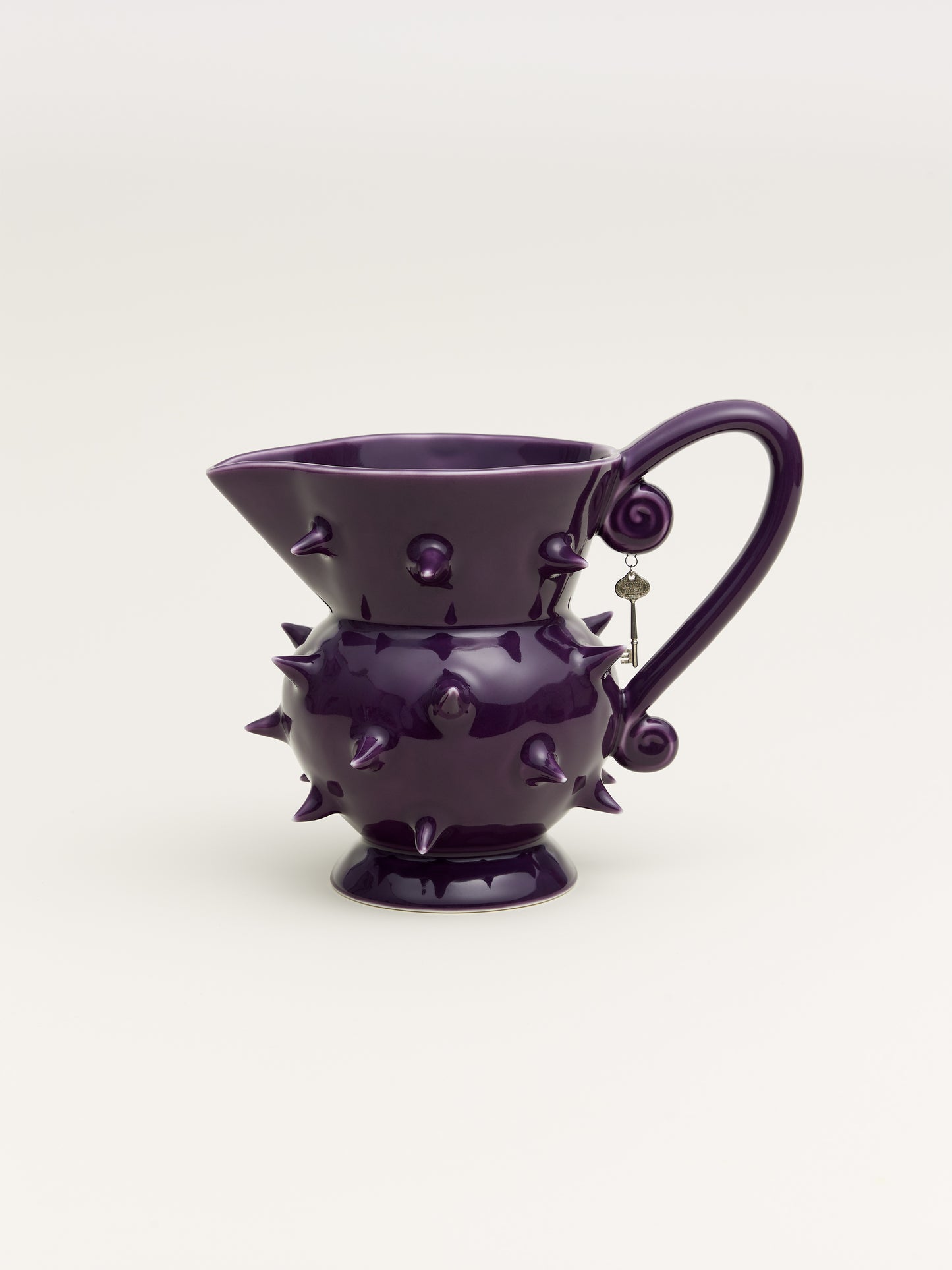 Handmade purple porcelain pitcher with a sleek design, ideal for displaying flowers or serving beverages in modern home decor