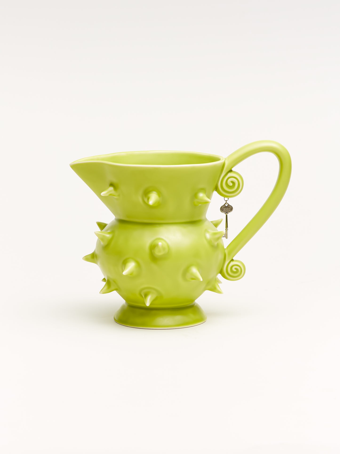 Handmade green porcelain pitcher with a smooth glazed finish, perfect for serving beverages or displaying flowers in your modern home decor