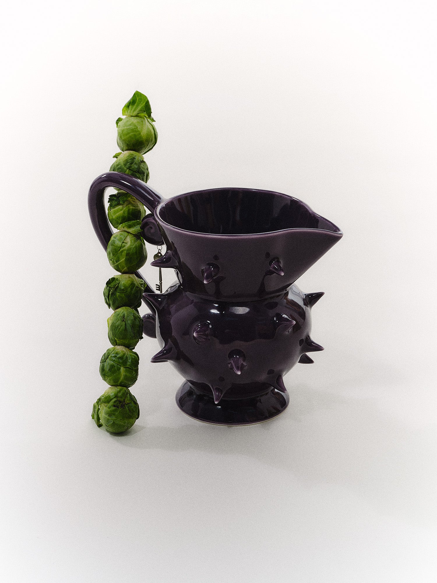 Unique handcrafted purple pitcher, a versatile ceramic jug for beverages or as a decorative piece for home decor